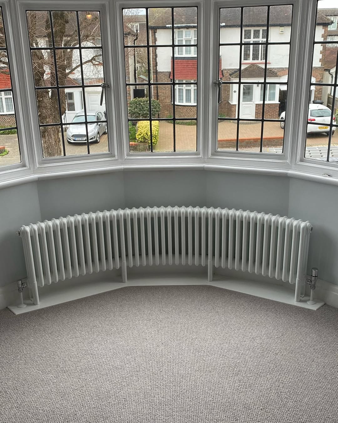 Column radiator installed in refurbished hallway