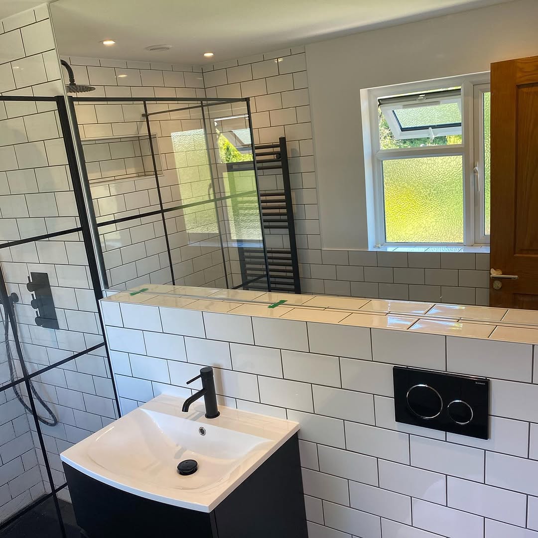 Full view of Lindfield en suite showing walk-in shower with black frame and hexagonal floor tiles