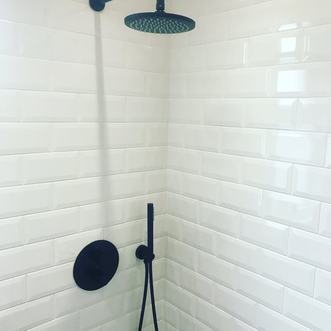 Matt black on white tile bathroom with walk-in shower